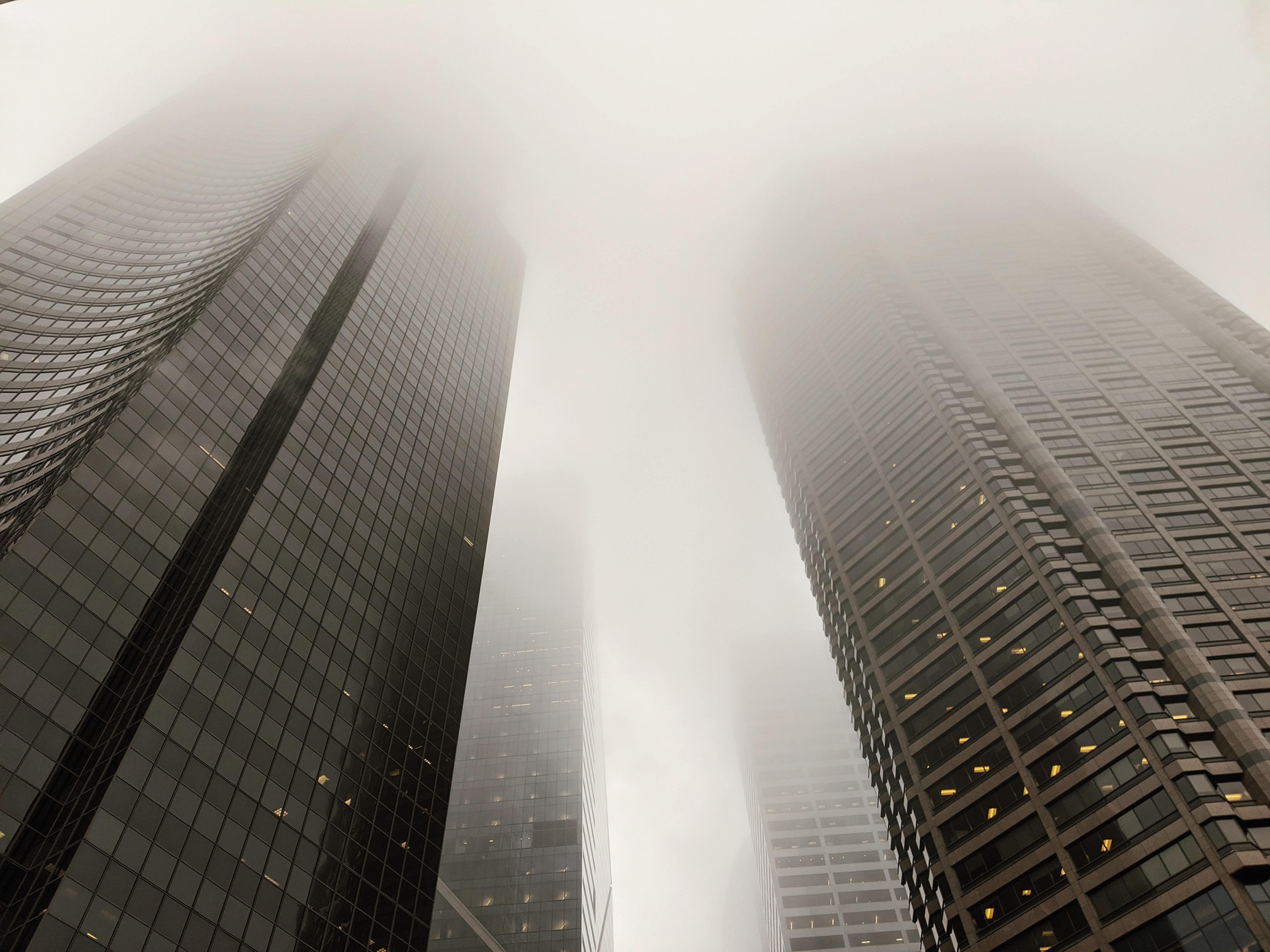 Modern skyscrapers against foggy sky